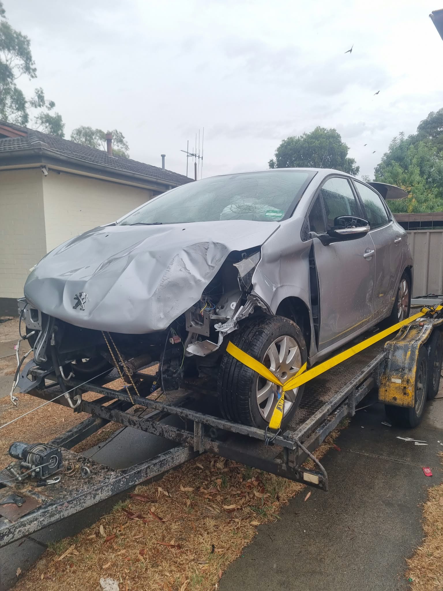 Damaged vehicle secured on a trailer for removal